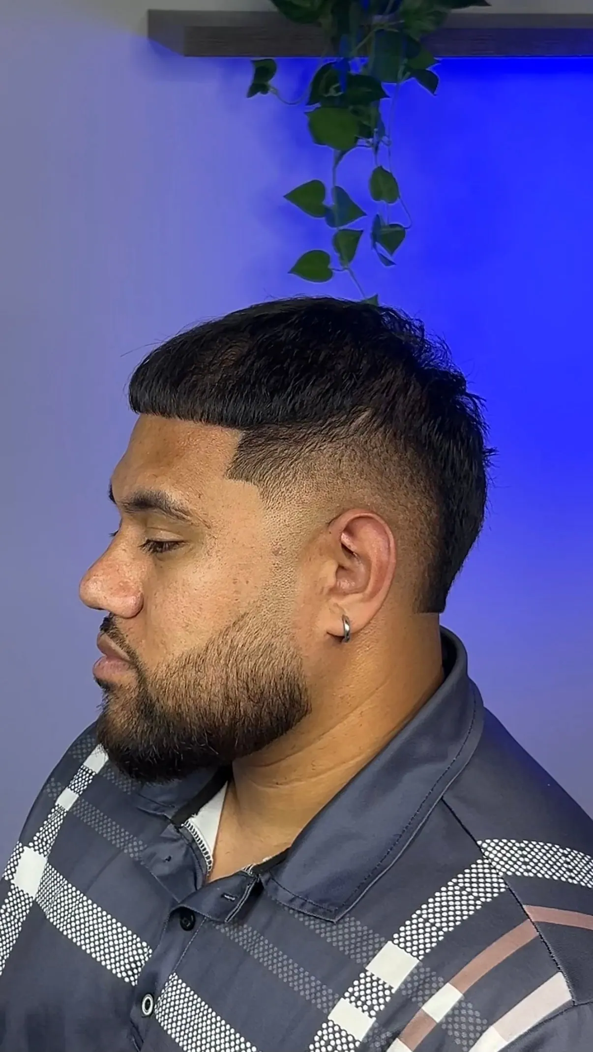 Blunt fringe edged square over a mid skin fade, finished with a shaped beard.