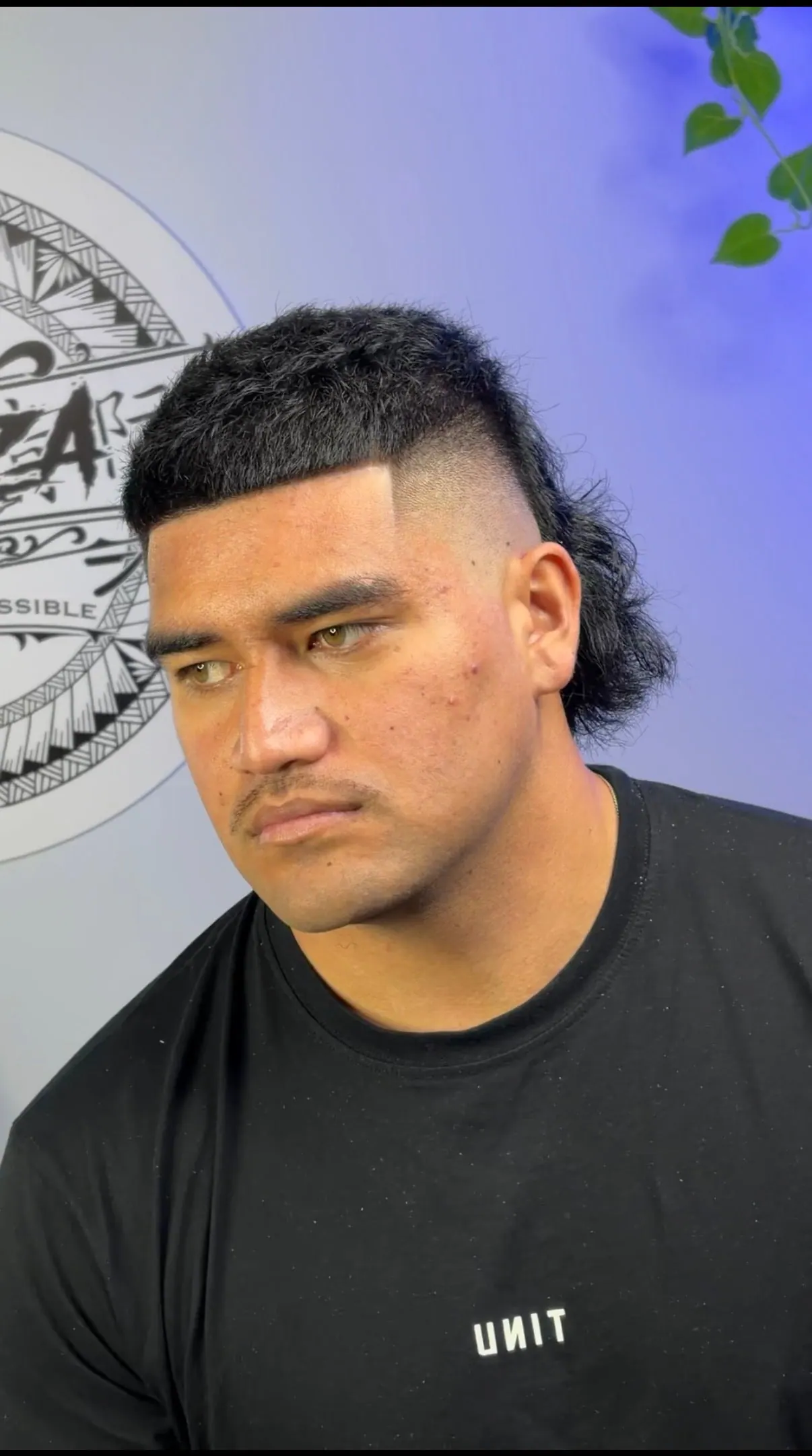 Square-edged flat top with a high skin fade through the sides and mullet length left at the back.