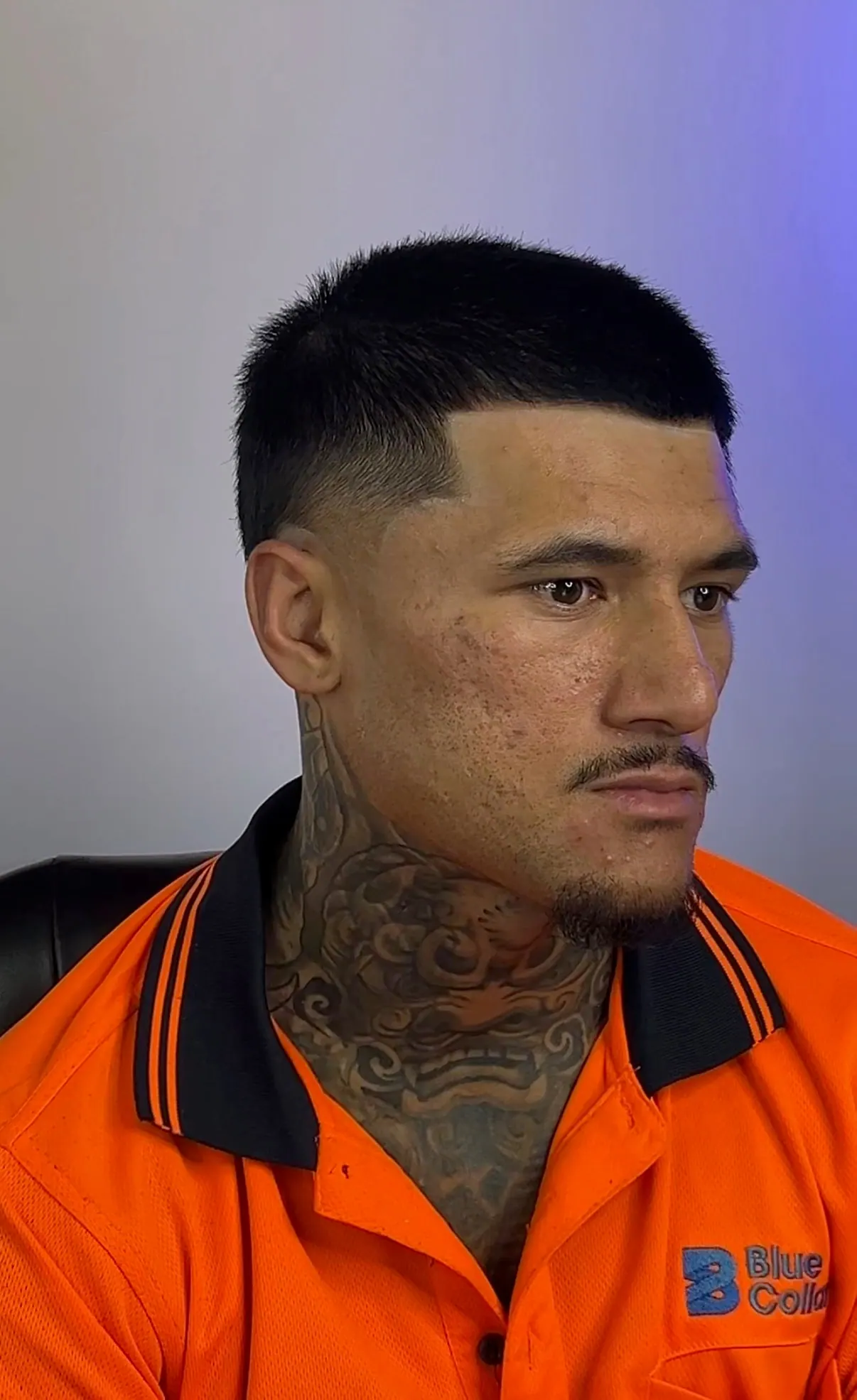 Close-cropped top with a straight edge-up, faded to skin around the ear.